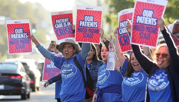 People hold placards, as a coalition of Kaiser Permanente Unions representing 75,000 healthcare workers at Kaiser Permanente starts a three-day strike across the United States over a new contract, in San Diego, California, US October 4, 2023.—Reuters