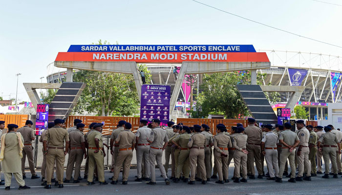 Police personnel gather outside the Narendra Modi Stadium in Ahmedabad on October 4, 2023. — AFP
