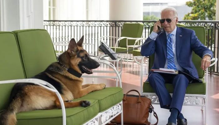 US President Joe Biden with his pet German shepherd dog in July 2022, on the Truman Balcony at the White House in Washington, DC.— The White House