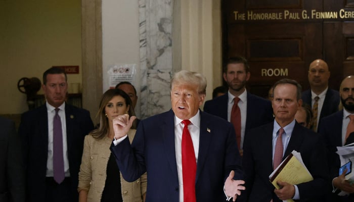 Former US President Donald Trump speaks to the media during the third day of his civil fraud trial in New York on October 4, 2023. — AFP