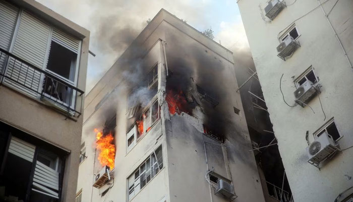 A building is ablaze following rocket attacks from the Gaza Strip, in Tel Aviv, Israel October 7, 2023. — Reuters