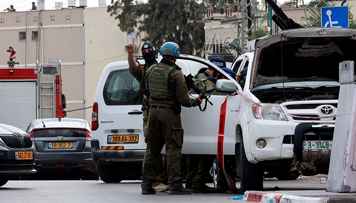 Israeli police inspect a car that has a Palestinian licence plate on it, following a mass infiltration by Hamas gunmen from the Gaza Strip, in Sderot, southern Israel October 7, 2023. — Reuters