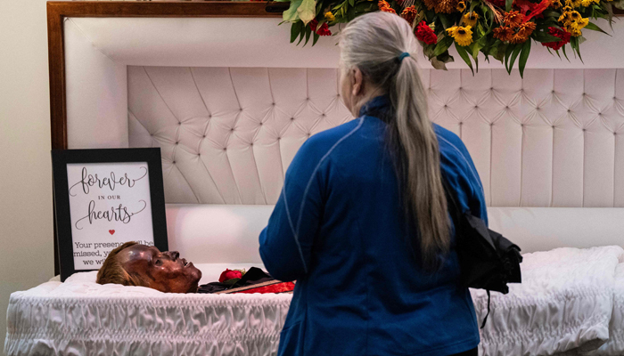 A woman visits the body of Stoneman Willie (James Murphy), during his funeral service in Reading, Pennsylvania, on October 7, 2023. — AFP