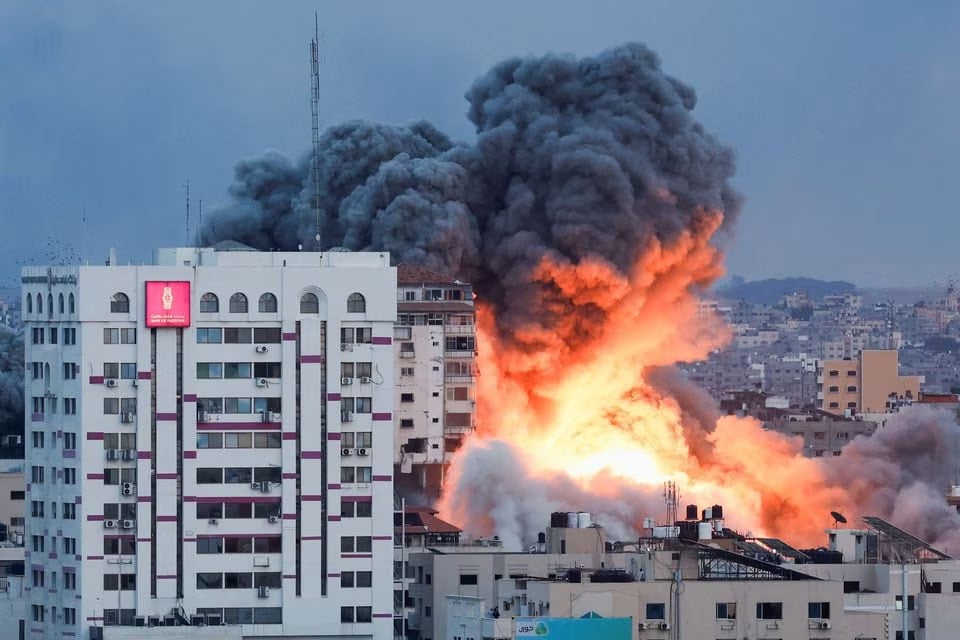Smoke and flames billow after Israeli forces struck a high-rise tower in Gaza City, October 7, 2023. — Reuters