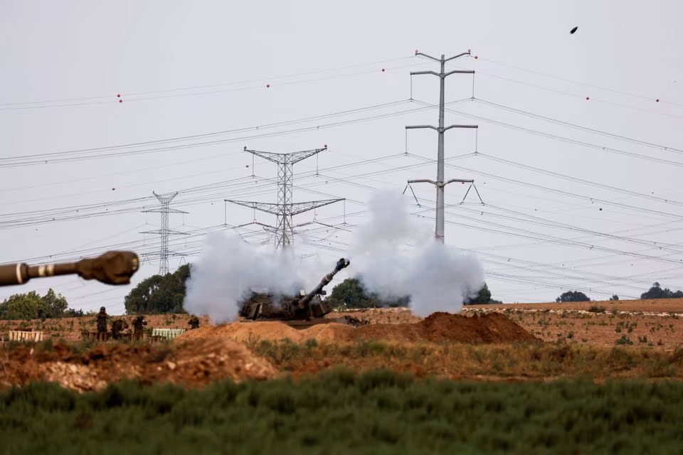An artillery unit fires near the Israeli side of the border between Israel and the Gaza Strip, October 8, 2023. — Reuters