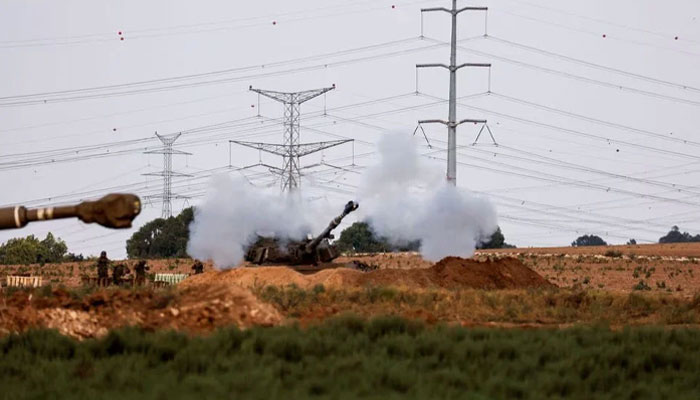A plume of smoke rises as artillery is fired after Hamass attack on Israel on October 9, 2023. — AFP