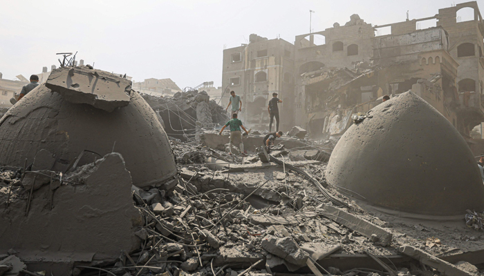 Palestinians inspect the damage following an Israeli airstrike on the Sousi mosque in Gaza City on October 9, 2023. — AFP