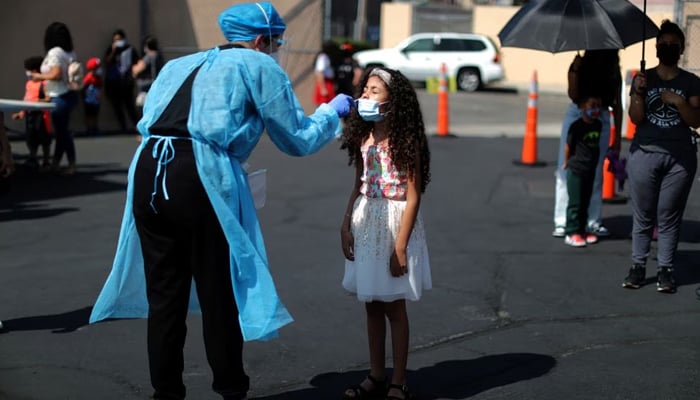 An 8-year-old girl is given a coronavirus disease test at a back-to-school clinic in South Gate, Los Angeles, California, US. on August 12, 2021. — Reuters