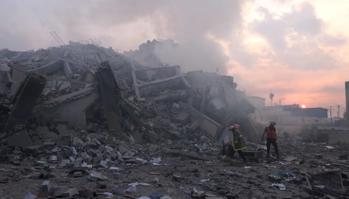 Palestinians inspect the damage outside Gaza City´s Al-Watan Tower, destroyed by an Israeli airstrike early on October 8, 2023. — AFP