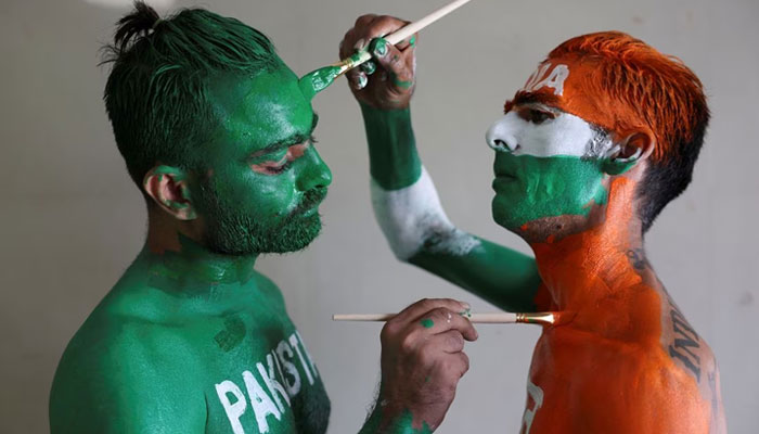 Cricket fans, Arun Haryani (right) and Anil Advani (left) paint their bodies in the Indian and Pakistani national flag colours, ahead of the match between India and Pakistan in the ICC World Cup, in Ahmedabad, India, October 11, 2023. — Reuters
