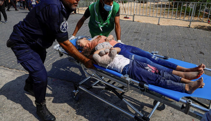 Palestinian children injured in Israeli strikes are brought to a hospital, in Gaza City, October 11. —Reuters