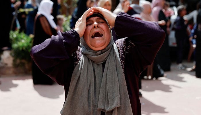 A woman reacts as mourners attend the funeral of four Palestinians killed in clashes with Israeli settlers, near Nablus in the Israeli-occupied West Bank, October 12. —Reuters