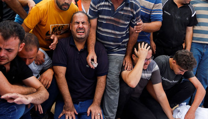 Mourners react during the funeral of Palestinian members of al-Agha family, who were killed in Israeli strikes, in Khan Younis in the southern Gaza Strip, October 11. — Reuters