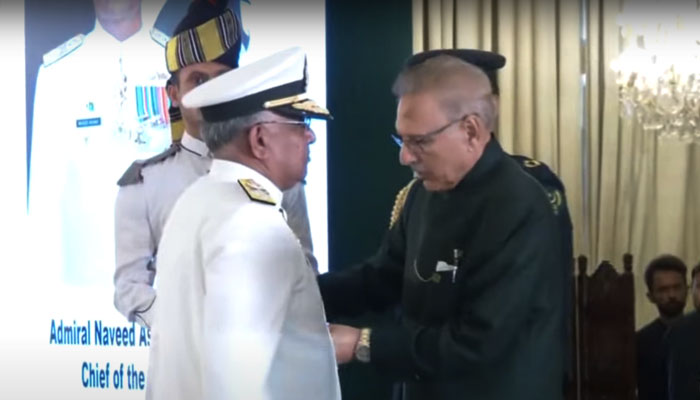 President Dr Arif Alvi (right) confers the Chief of Naval Staff Admiral Naveed Ashraf with Nishan-e-Imtiaz Military on October 13, 2023, in this still taken from a video. — YouTube/PTV News Live