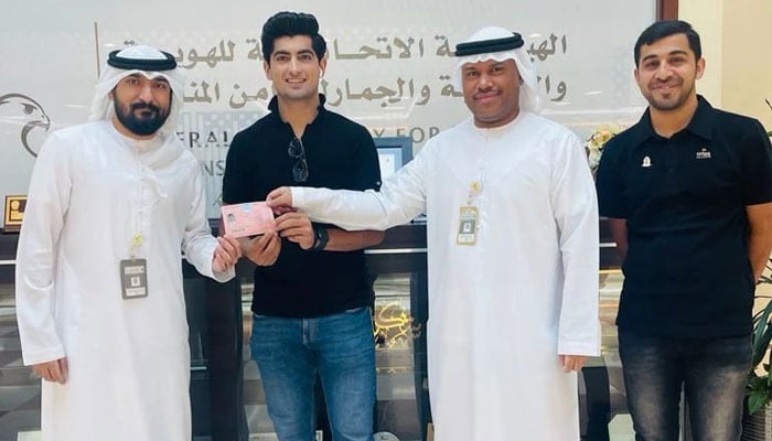 Pakistani cricketer Naseem Shah (centre) receives his UAE golden visa from GRFA Dubai officials in Dubai with blogger Moazzam Qureshi in attendance. — Instagram/@inaseemshah