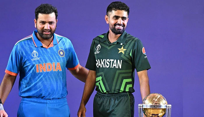 Indias captain Rohit Sharma (left) with Pakistan skipper Babar Azam stand beside the trophy during the Captains Day event at the Narendra Modi Stadium in Ahmedabad, India on October 4, 2023. — AFP