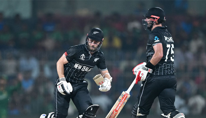 New Zealand´s captain Kane Williamson (left) and Daryl Mitchell run between the wickets during the 2023 ICC Men´s Cricket World Cup ODI match between New Zealand and Bangladesh at the MA Chidambaram Stadium in Chennai on October 13, 2023