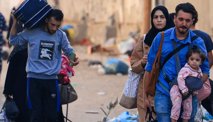 Palestinians fleeing Gaza City on 13 October.—AFP
