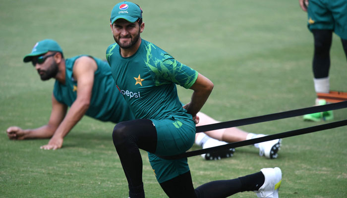 Pakistans Shaheen Shah Afridi stretches during a practice session at the Rajiv Gandhi International Stadium in Hyderabad on October 5, 2023. — AFP