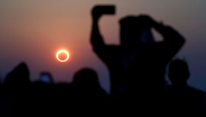 People take photos with their smartphones as they monitor the annular solar eclipse on Jabal Arba (Four Mountains) in Hofuf, in the Eastern Province of Saudi Arabia, December 26, 2019. — Reuters