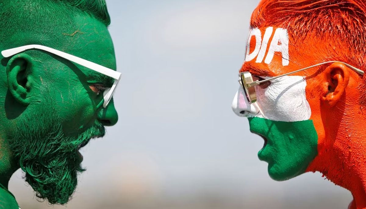 Cricket fans, with their faces painted in the Indian and Pakistani national flag colours, pose for a picture ahead of the first match between India and Pakistan in Twenty20 World Cup super 12 stage in Dubai, in Ahmedabad, India, October 23, 2021. — Reuters