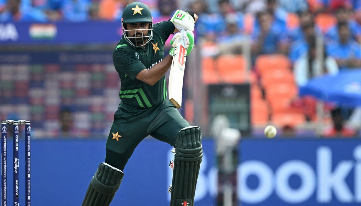 Pakistan´s captain Babar Azam watches the ball after playing a shot during the 2023 ICC Men´s Cricket World Cup one-day international (ODI) match between India and Pakistan at the Narendra Modi Stadium in Ahmedabad on October 14, 2023. — AFP