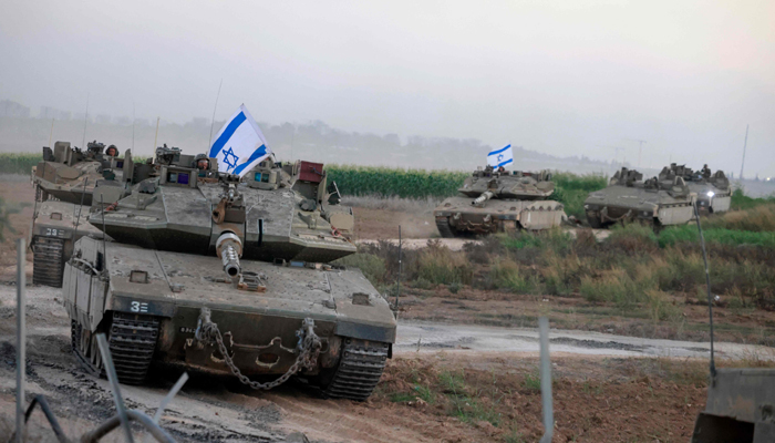 A convoy of Israeli tanks advances near the border with Gaza on October 12, 2023. — AFP