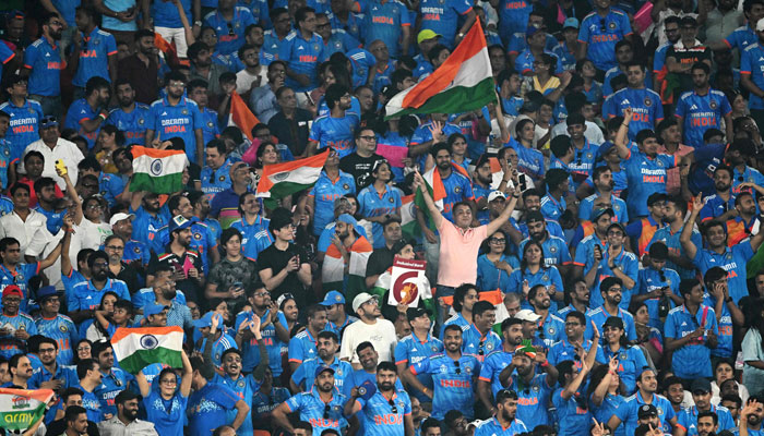 NeIndia fans cheer during the 2023 ICC Men´s Cricket World Cup one-day international (ODI) match between India and Pakistan at the Narendra Modi Stadium in Ahmedabad on October 14, 2023. — AFP