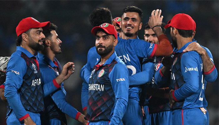 Afghanistan´s Naveen-ul-Haq (centre) celebrates with teammates after taking the wicket of England´s captain Jos Buttler during the 2023 ICC Men´s Cricket World Cup ODI match between England and Afghanistan at the Arun Jaitley Stadium in New Delhi on October 15, 2023. — AFP
