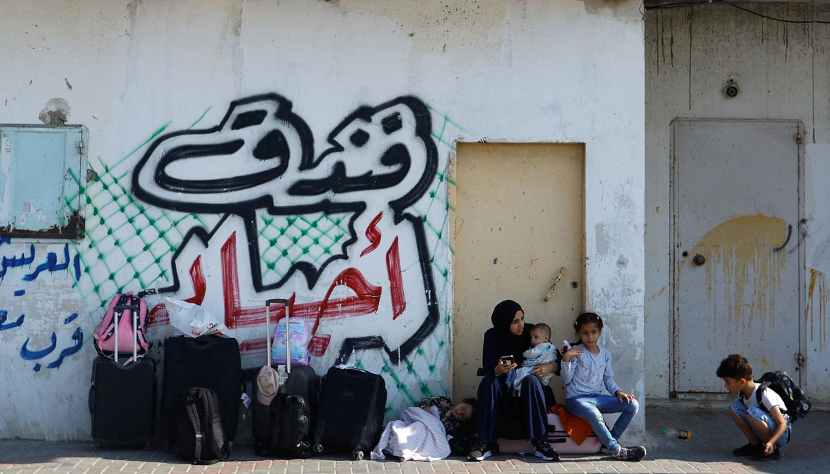 Palestinians wait outside Rafah border crossing with Egypt, in Rafah in the southern Gaza Strip on October 14, 2023. — Reuters