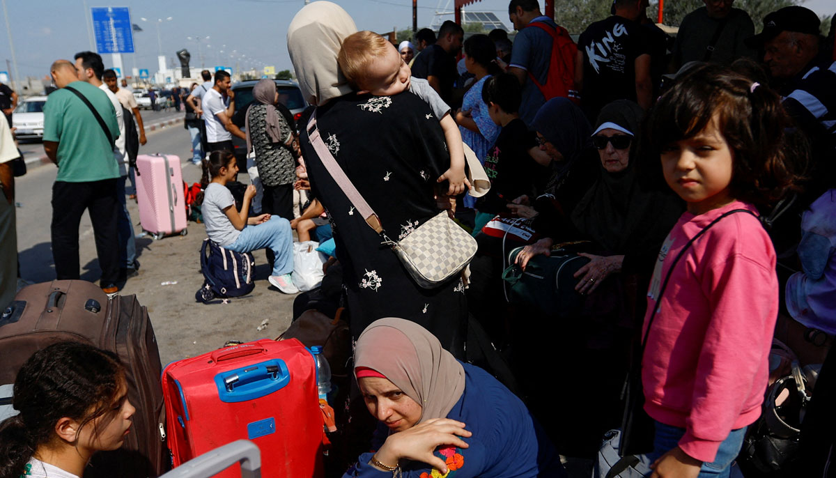 Palestinians with wait outside Rafah border crossing with Egypt in the hope of getting permission to leave Gaza, in Rafah in the southern Gaza Strip on October 14, 2023. — Reuters