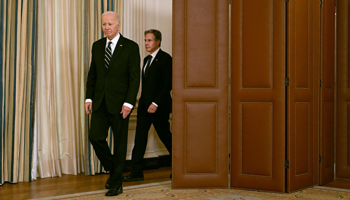 US President Joe Biden, with Secretary of State Antony Blinken, arrives to address the attacks in Israel from the State Dining Room of the White House in Washington, DC, on October 7, 2023. — AFP