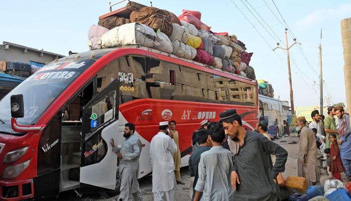 Afghan refugees wait to board a bus to depart for Afghanistan in Karachi on October 10, 2023. — Online