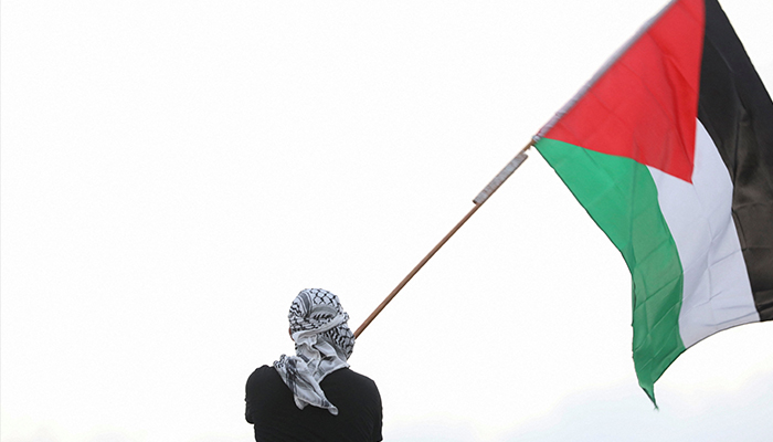 A man waves a Palestinian flag, as people take part in a pro-Palestinian protest in Amman, Jordan, October 18, 2023. — Reuters