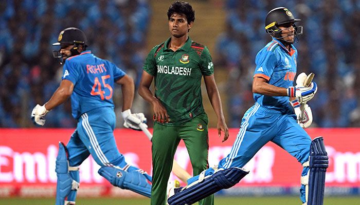 India´s Shubman Gill (R) and captain Rohit Sharma (L) run between the wickets during the 2023 ICC Men´s Cricket World Cup one-day international (ODI) match between India and Bangladesh at the Maharashtra Cricket Association Stadium in Pune on October 19, 2023. — AFP