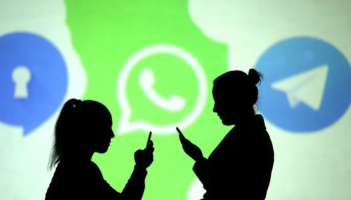 Silhouettes of mobile users are seen next to logos of social media apps Signal, Whatsapp and Telegram projected on a screen in this picture illustration. —Reuters/file