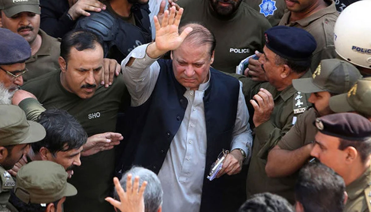 Police escort jailed former Pakistani prime minister Nawaz Sharif, center, as he leaves the accountability court in Lahore on October 11, 2019. — AFP