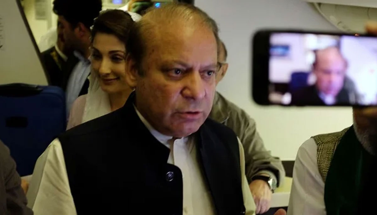 Ousted Pakistani Prime Minister Nawaz Sharif gestures as he boards a Lahore-bound flight due for departure, at Abu Dhabi International Airport, UAE July 13, 2018. — Reuters
