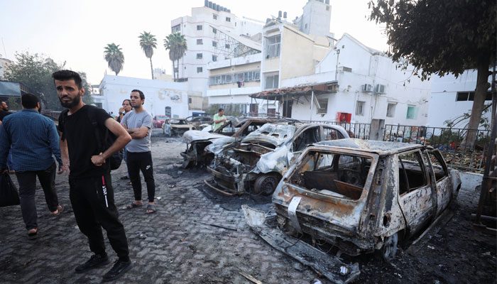 People inspect the area of Al-Ahli hospital where hundreds of Palestinians were killed in a blast that Israeli and Palestinian officials blamed on each other, and where Palestinians who fled their homes were sheltering amid the ongoing conflict with Israel, in Gaza City, October 18, 2023. — Reuters
