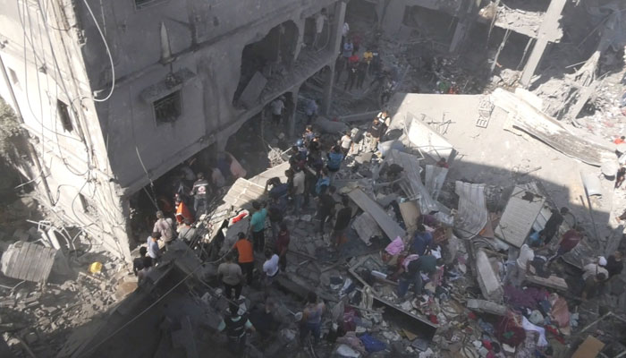 People work to remove the debris as they search for victims after a blast amid the ongoing conflict between Israel and Hamas, in Gaza City, October 18, 2023, as seen in this screen grab taken from a handout video. — Reuters
