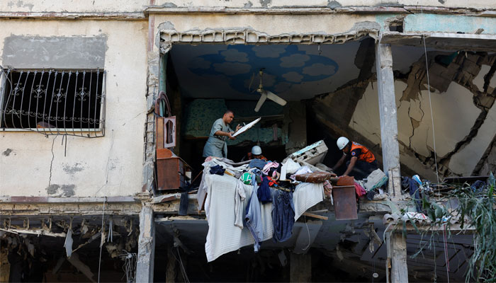 Rescue workers move debris at the site of Israeli strikes on a house, amid the ongoing conflict between Israel and Hamas, in Khan Younis, southern Gaza Strip October 20, 2023. — Reuters