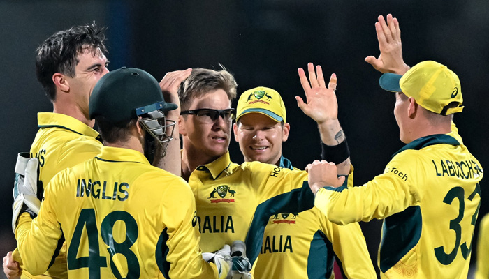 Australias Adam Zampa (C) celebrates with teammates after taking the wicket of Pakistan´s captain Babar Azam during the 2023 ICC Men´s Cricket World Cup one-day international (ODI) match between Australia and Pakistan at the M. Chinnaswamy Stadium in Bengaluru on October 20, 2023. — AFP