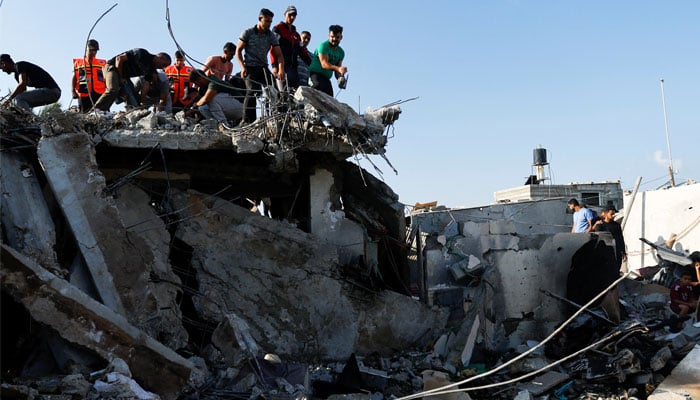 Palestinians work to remove debris as they search for bodies at a house destroyed in an Israeli strike, amid the ongoing conflict between Israel and Palestinian Islamist group Hamas, in Khan Younis in the southern Gaza Strip, October 19, 2023. — Reuters