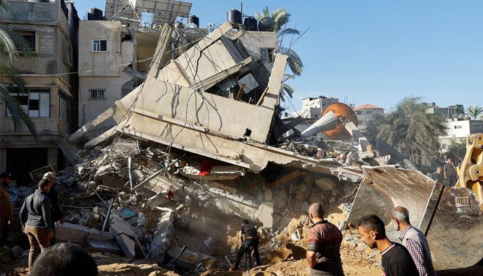 Palestinians search for casualties at the site of an Israeli strike on a house, in Khan Younis, in the southern Gaza Strip, October 21, 2023. — Reuters