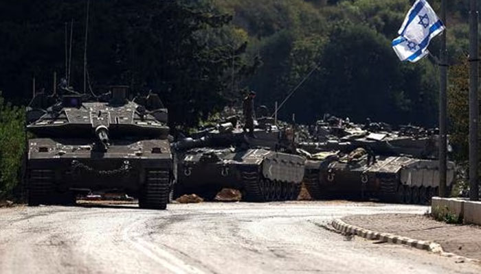 Israeli tanks are seen on a road near Israels border with Lebanon, in northern Israel, October 12, 2023.—Reuters