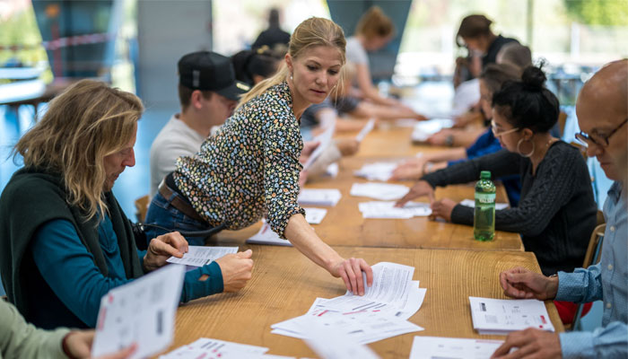Electoral workers count ballots during Swiss federal elections to elect a new Parliament, in Bern, Swiss capital on October 22, 2023.—AFP