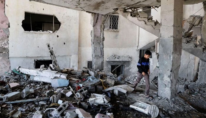 A Palestinian boy checks the damage at a mosque which was hit in an Israeli air strike, in Jenin refugee camp in the Israeli-occupied West Bank on October 22, 2023. — Reuters
