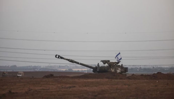 An Israeli flag flutters from a self-propelled howitzer near Israels border with the Gaza Strip, in southern Israel, October 22, 2023. — Reuters