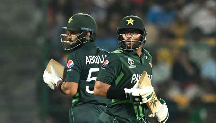 Imam-ul-Haq (R) and Abdullah Shafique run between the wickets during the 2023 ICC Mens Cricket World Cup one-day international (ODI) match between Australia and Pakistan at the M. Chinnaswamy Stadium in Bengaluru on October 20, 2023. —AFP
