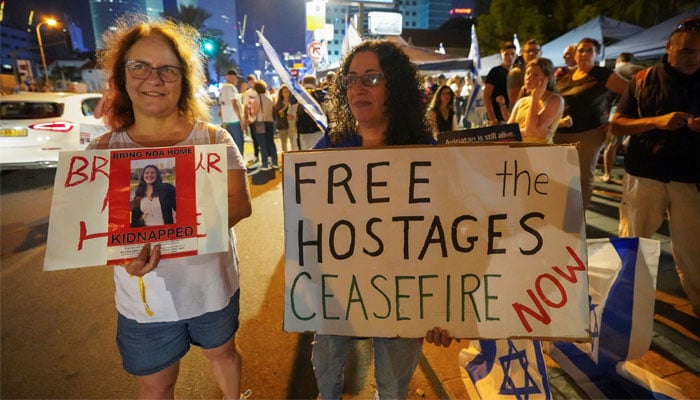 People hold placards during a demonstration to show support and solidarity with the families of hostages who are being held in Gaza, amid the ongoing conflict between Israel and Palestine, in Tel Aviv, Israel, October 21, 2023. — Reuters